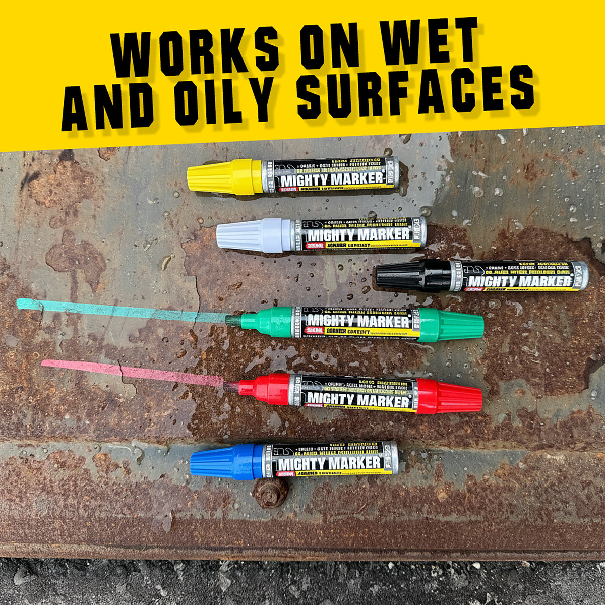PM-23 Mighty Marker pens in various colors on a wet and oily surface with text 'Works on Wet and Oily Surfaces'.