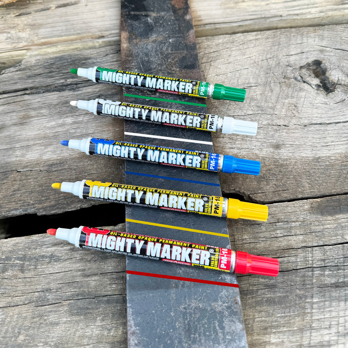 Set of Mighty Marker pens in various colors on a wooden surface
